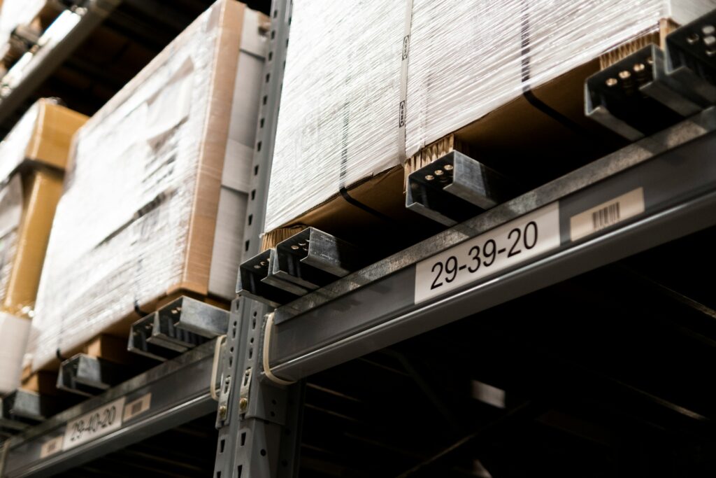 Warehouse performance metrics tracked through labeled pallet storage locations and organized inventory racks