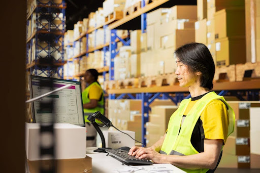 A man overseeing inventory on a computer
