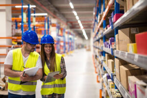 Warehouse employees working together on checking inventory