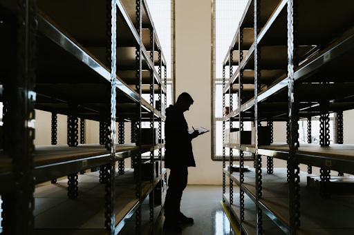 A warehouse worker inspecting inventory