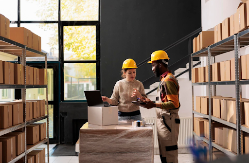 Warehouse employees analyzing goods logistics