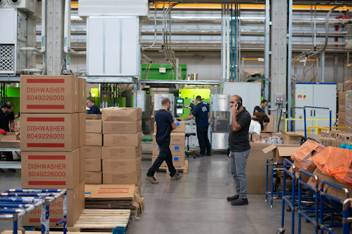 Warehouse employees working among stacked boxes