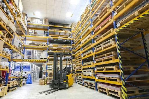 Warehouse storage system with organized pallet racks and forklift