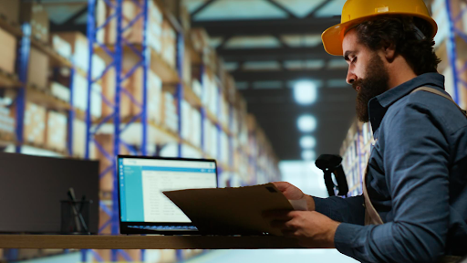 Warehouse worker reviewing inventory records in a distribution center