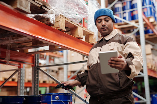 Warehouse worker using a tablet to manage inventory