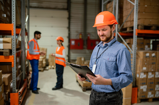 Warehouse workers efficiently managing inventory with digital tablets