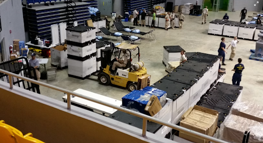Warehouse workers handling inventory and materials with a forklift