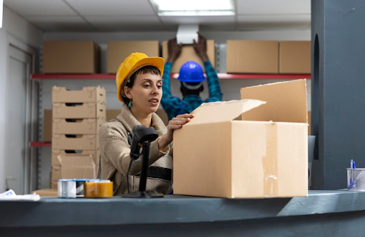 Warehouse workers processing inbound inventory at a receiving station