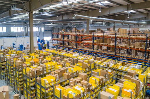 Warehouse storage racks with boxes and inventory bins
