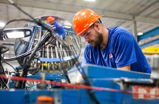 Worker handling machinery in an industrial facility